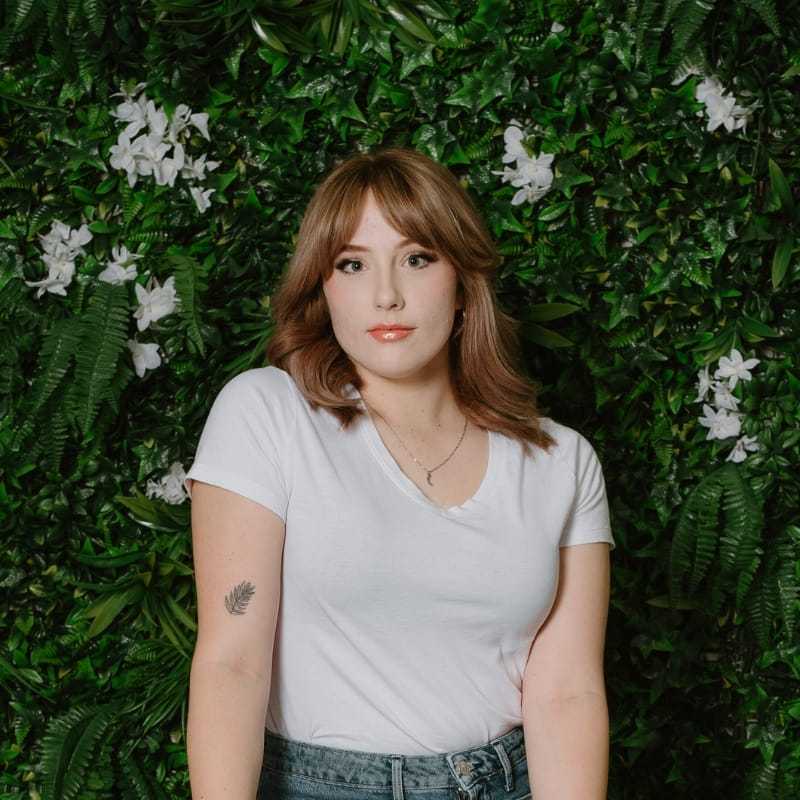 Portrait of Sophie, a professional stylist at Utopia Salon, showcasing their expertise and style.