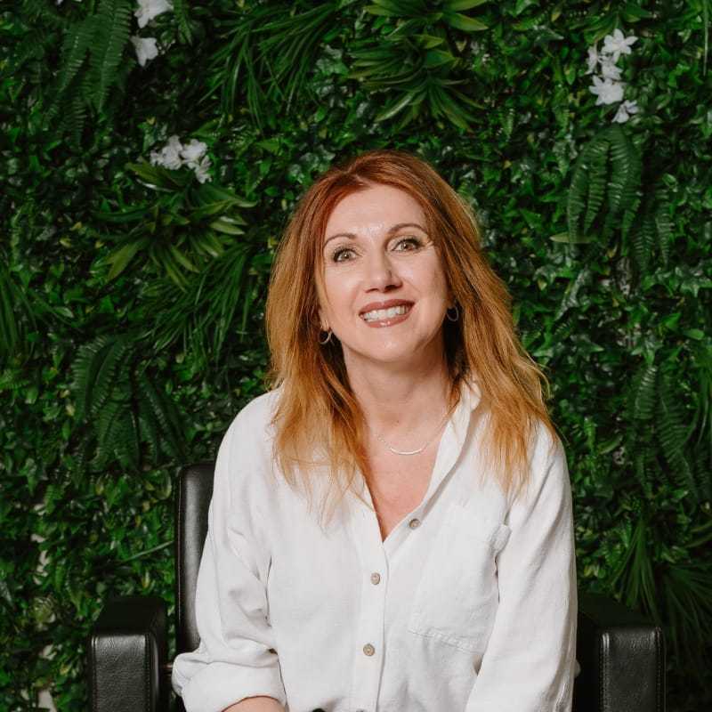 Portrait of Lisa Houser, a professional stylist at Utopia Salon, showcasing their expertise and style.