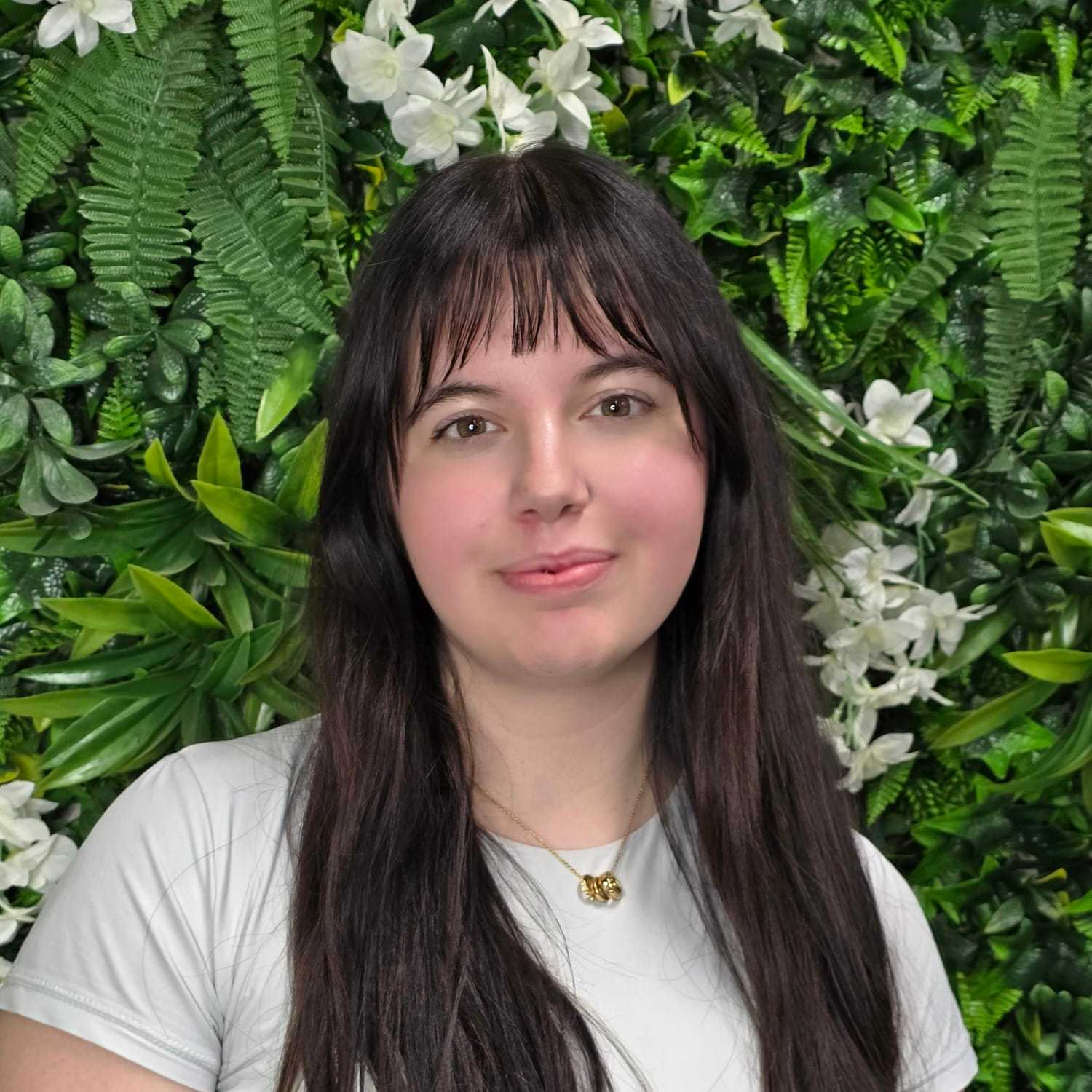 Portrait of Angie, a professional stylist at Utopia Salon, showcasing their expertise and style.