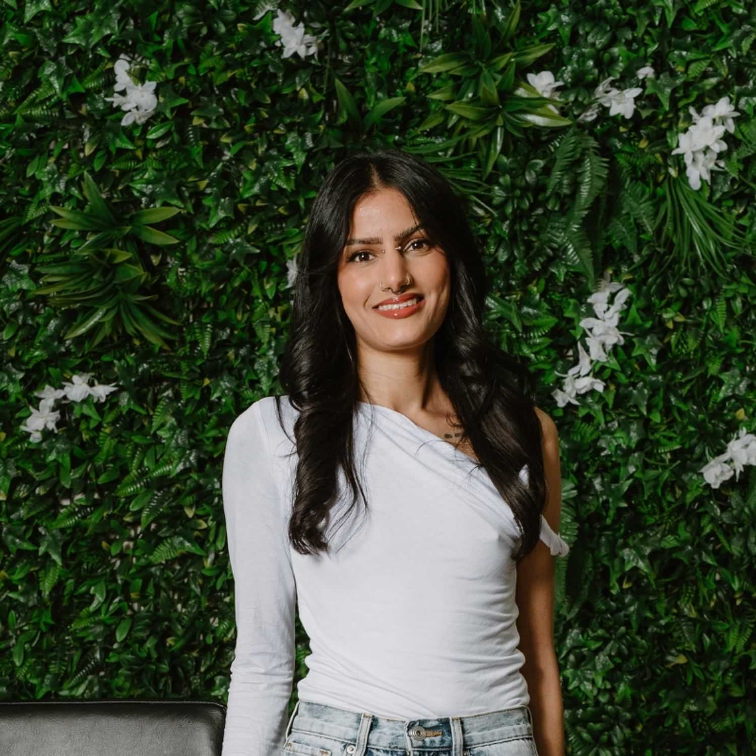 Portrait of Madhi Lair, a professional stylist at Utopia Salon, showcasing their expertise and style.