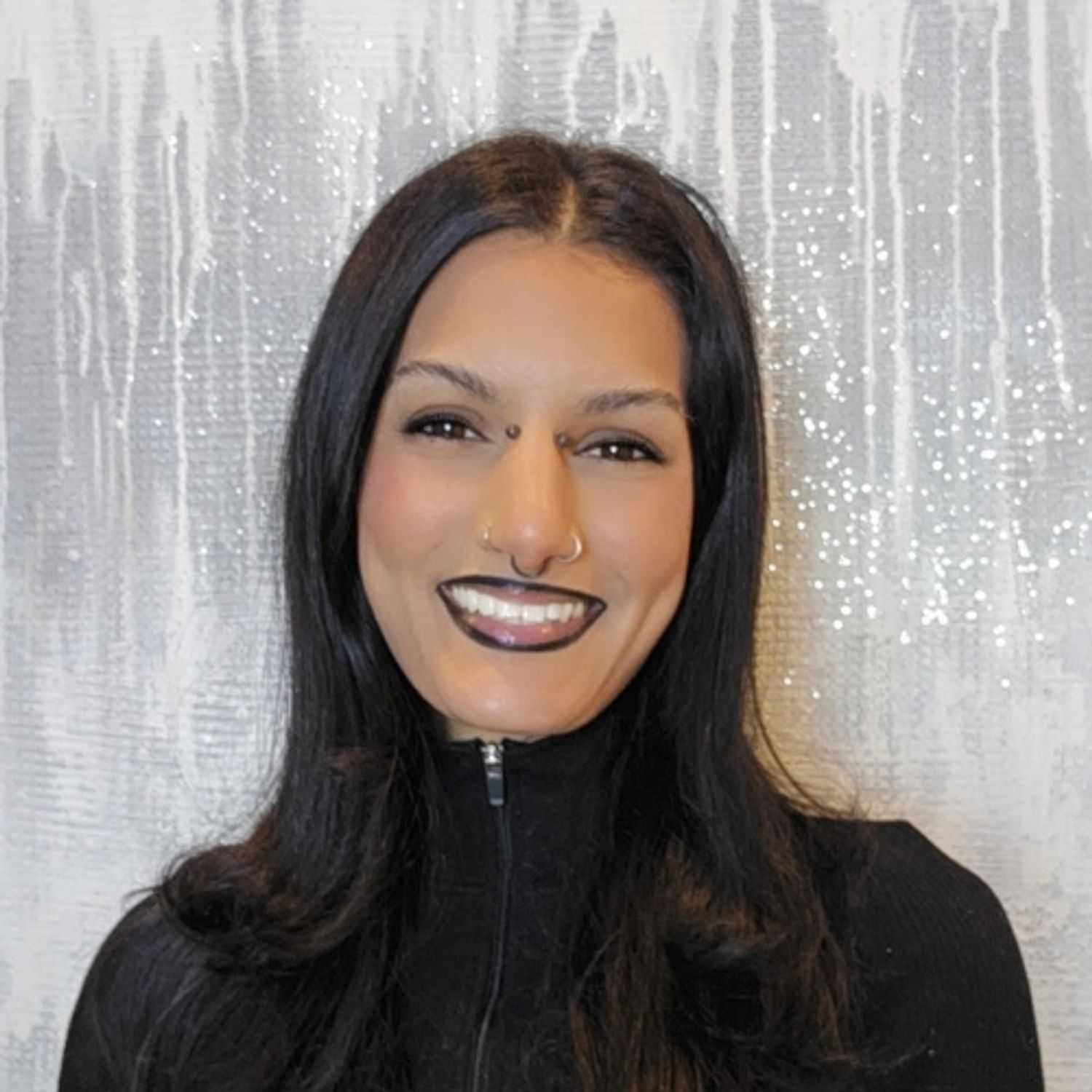 Portrait of Madhi Lair, a professional stylist at Utopia Salon, showcasing their expertise and style.