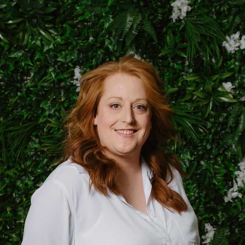 Portrait of Jessie, a professional stylist at Utopia Salon, showcasing their expertise and style.