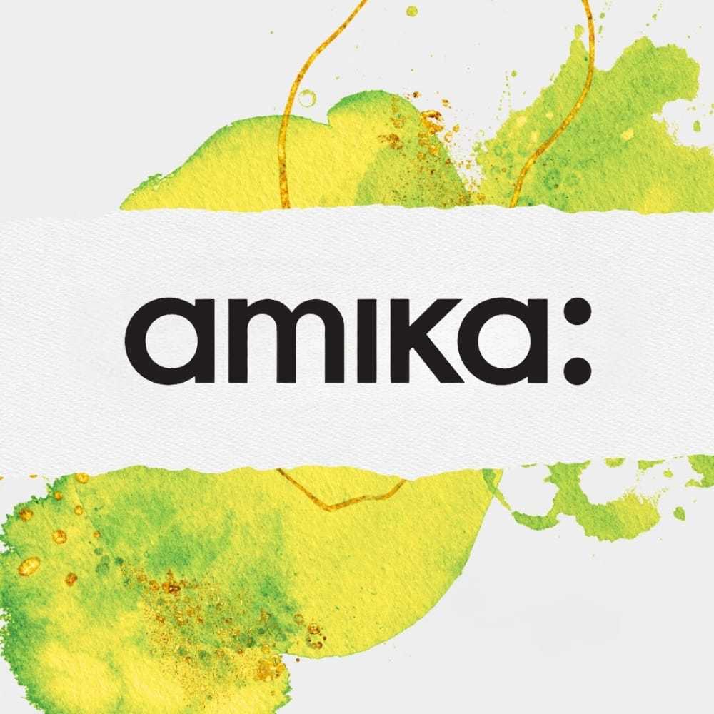 amika logo on white, with green and yellow watercolor background stains.